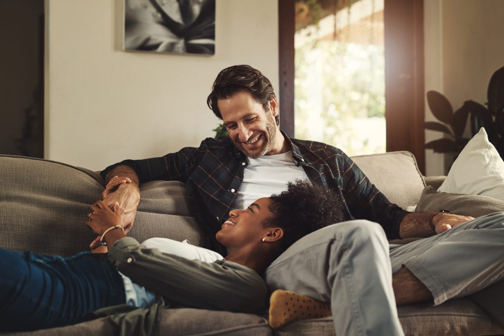 Shot of a happy young couple relaxing on a sofa and spending time together at home.