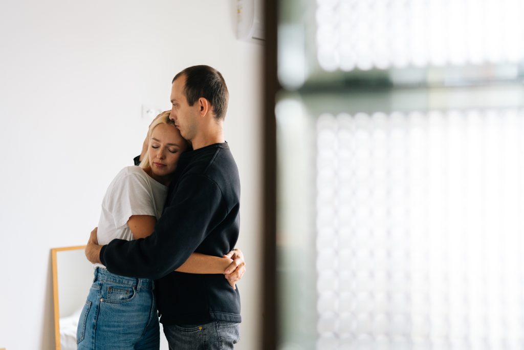 man and woman hugging each other
