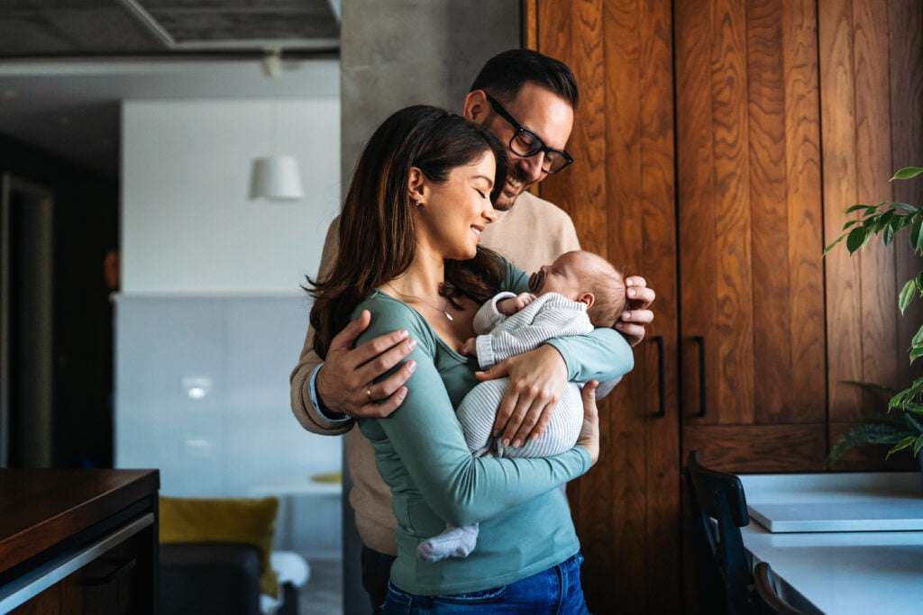 man and woman with baby