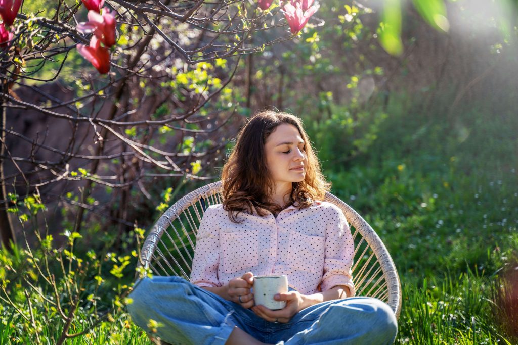 young woman sitting on chair, holding a book
