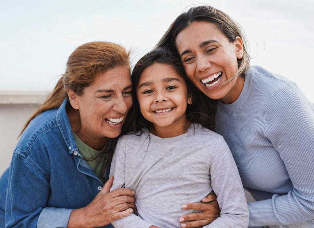 Happy latin multi generational family having tender moment together outdoor - Female child smiling on camera Happy latin multi generational family having tender moment together outdoor - Female child smiling on camera