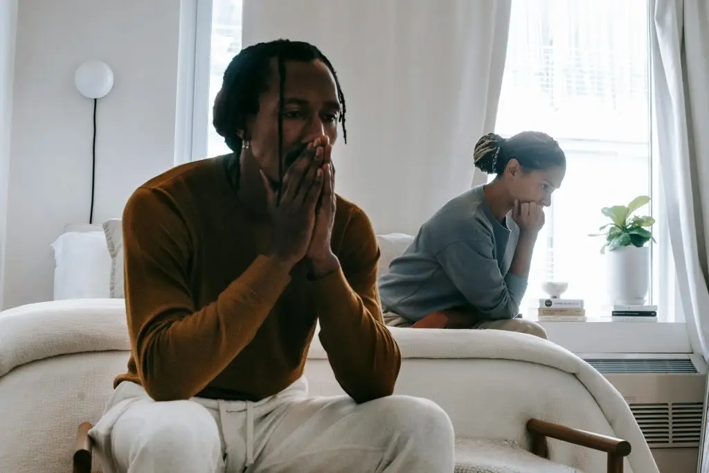 Couple experiencing emotional distance after conflict, symbolizing communication challenges in neurodiverse relationships and couples therapy.